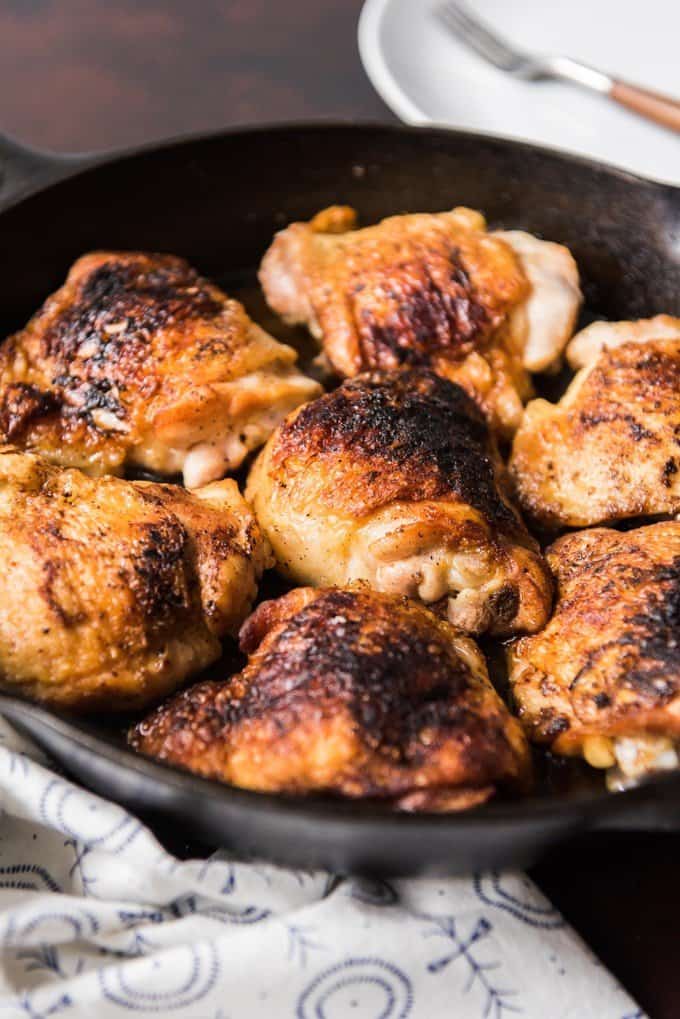 cooked chicken thighs in a cast iron skillet