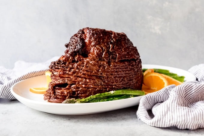 An image of a brown sugar glazed ham with orange juice, molasses, and horseradish.