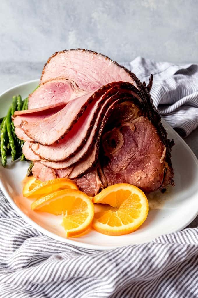 An image of a whole spiral-cut ham roast with brown sugar glaze served on a platter for Christmas dinner.