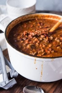 a large white pot filled with meaty mushroom chili