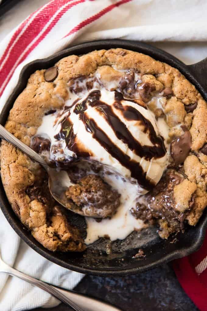 a skillet cookie topped with ice cream and some removed