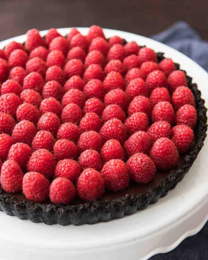 Fresh raspberries atop a chocolate tart with chocolate crust.