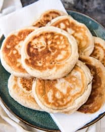 a plate with a pile of korean pancakes on top of paper towels