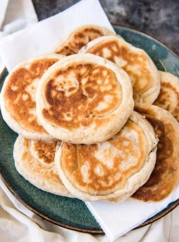 a plate with a pile of korean pancakes on top of paper towels