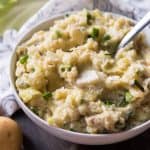 a bowl filled with creamy colcannon and butter