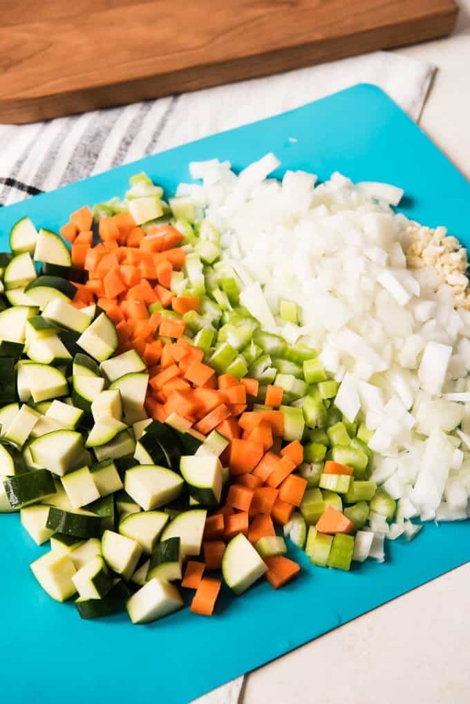 Chopped vegetables on a cutting board for minestrone soup.
