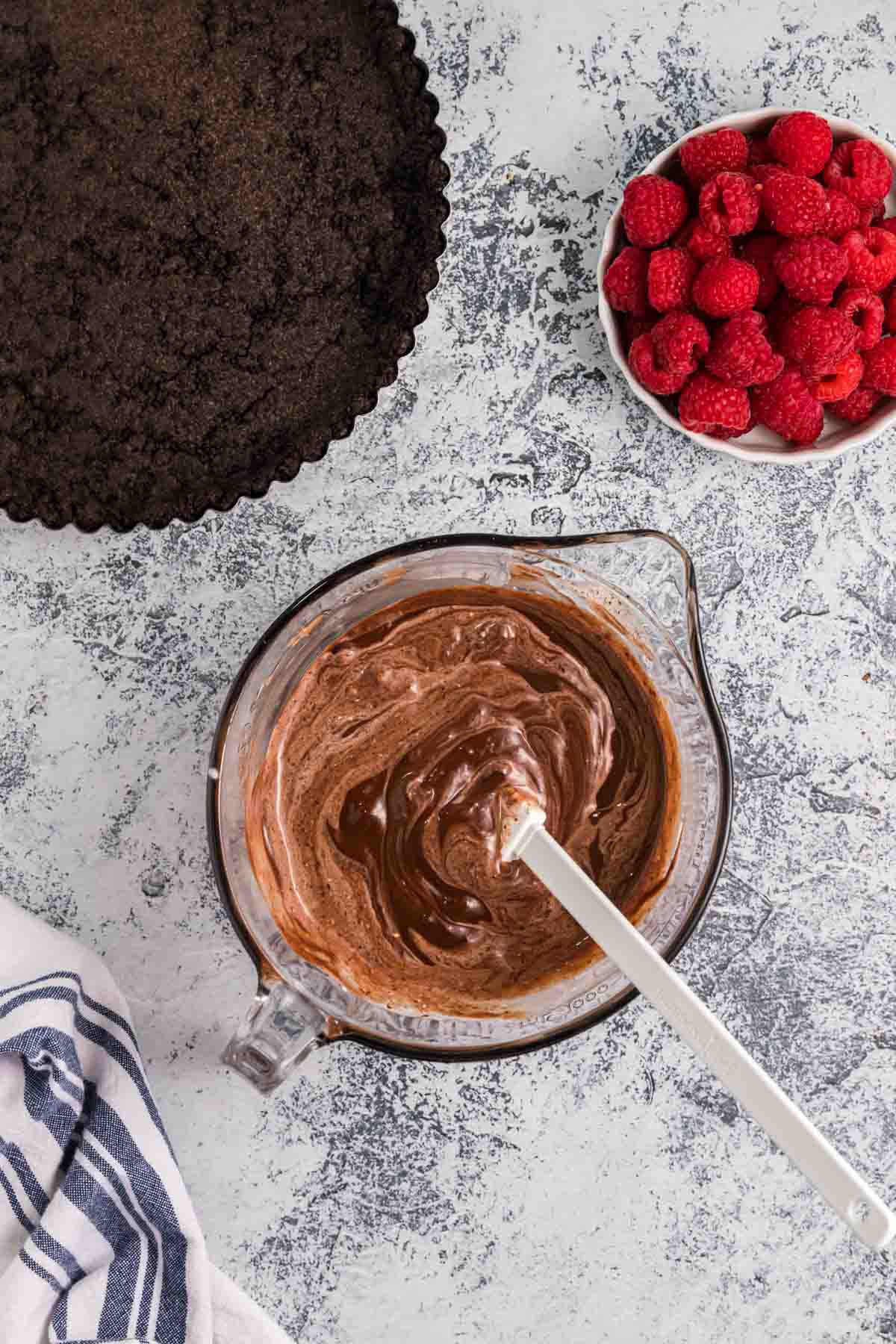 Stirring chocolate ganache in a bowl.