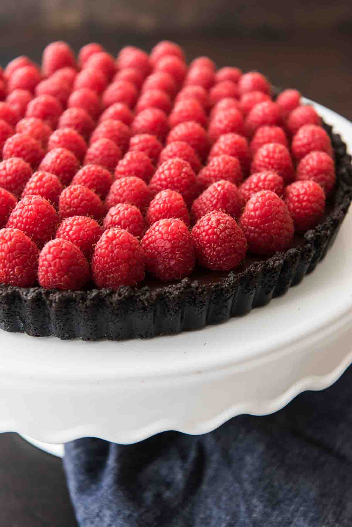 Fresh raspberries atop a chocolate tart with chocolate crust.