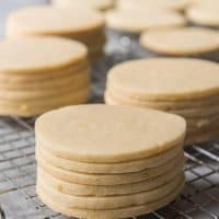 stacks of unfrosted sugar cookies on a wire cooling rack