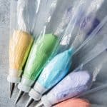 frosting piping bags with fitted tips and each conatining a different color of royal icing