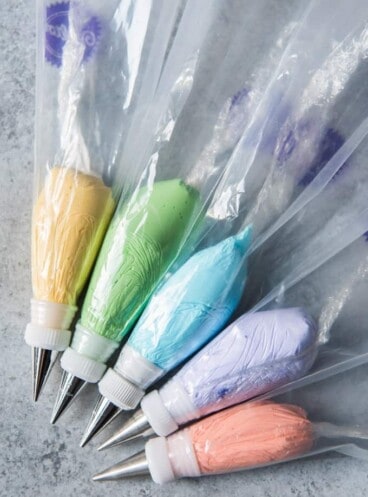 frosting piping bags with fitted tips and each conatining a different color of royal icing