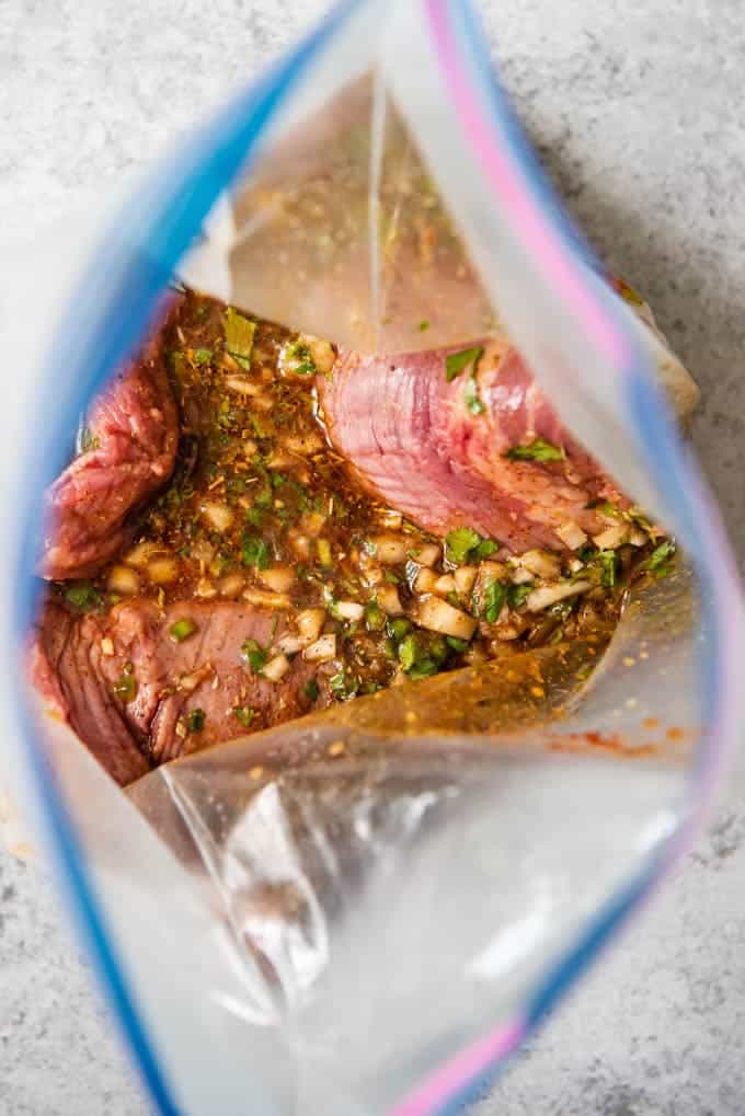 An image of a piece of flank steak in the best carne asada marinade.