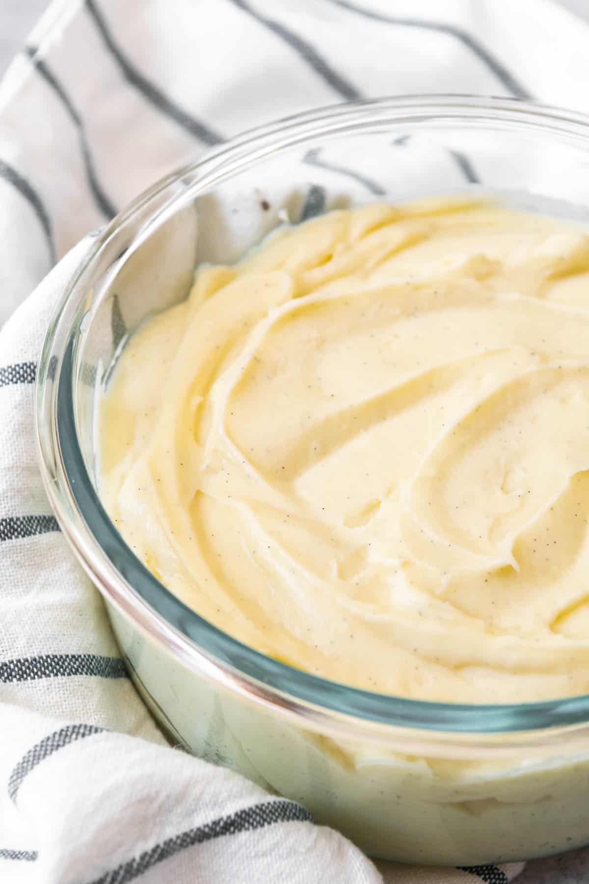 A bowl of rich vanilla bean custard for filling tarts, cream puffs, eclairs, cakes, and pies, known as French pastry cream.