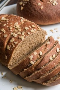 sliced brown molasses bread with oats on top