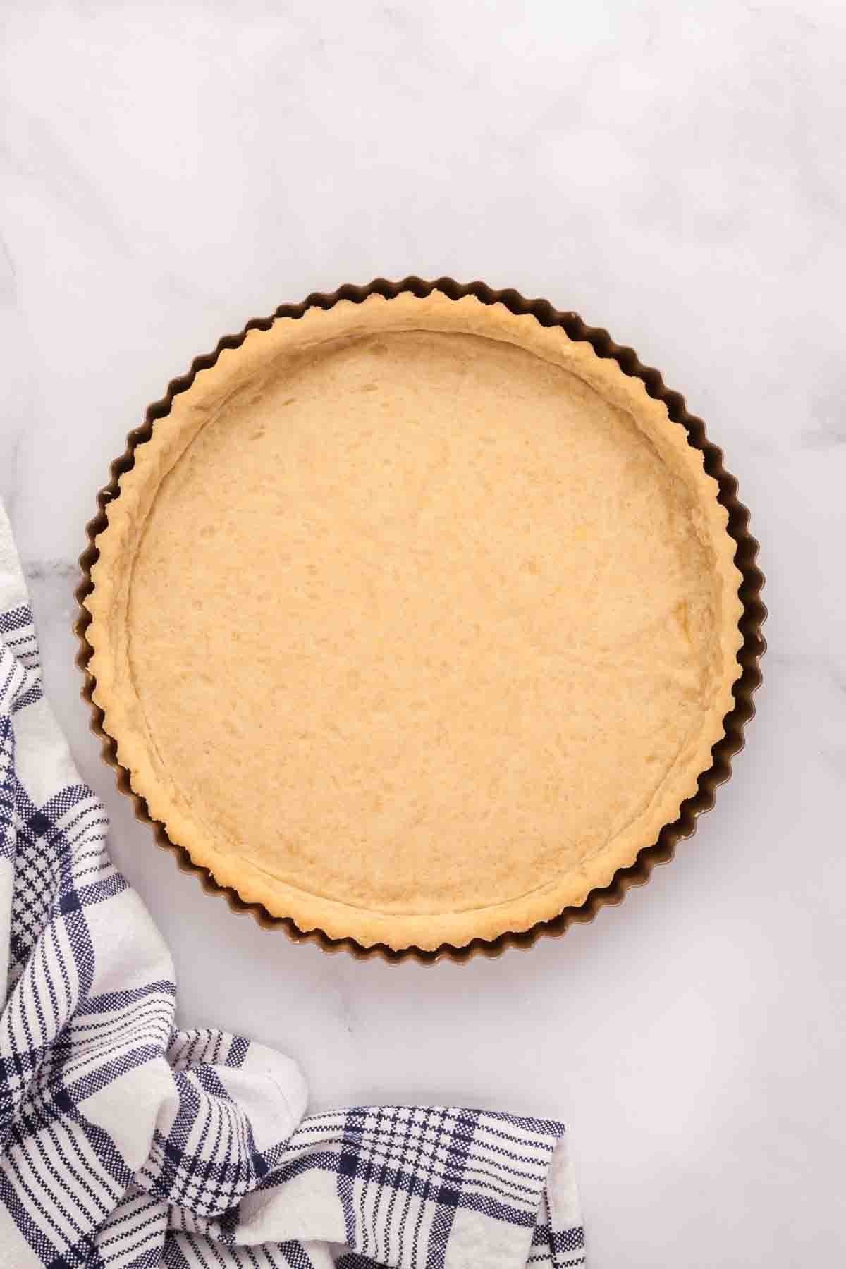 An image of a blind-baked pate sucree sweet pastry crust tart shell for a fresh fruit tart.