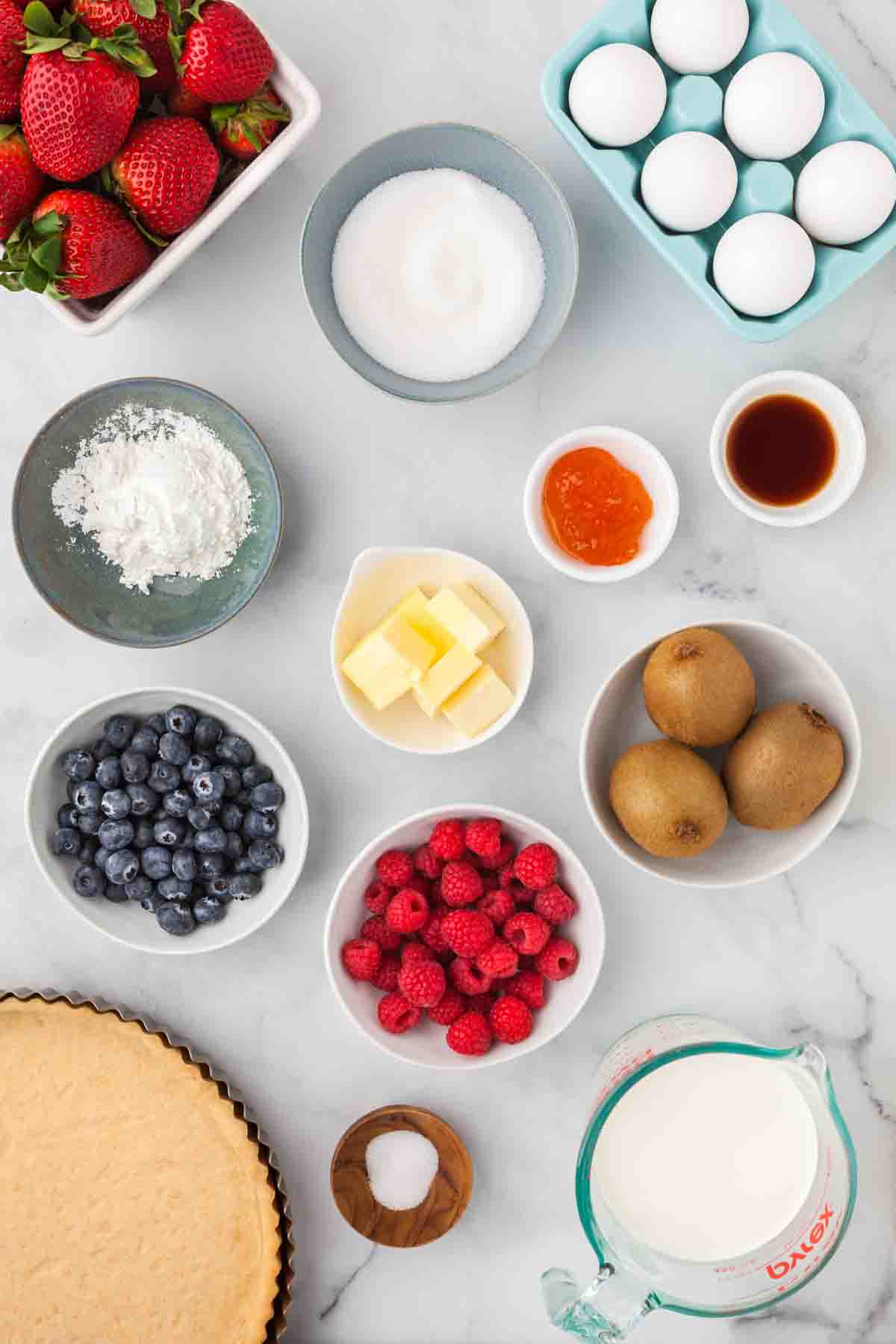 An overhead image of ingredients for making a french fruit tart.