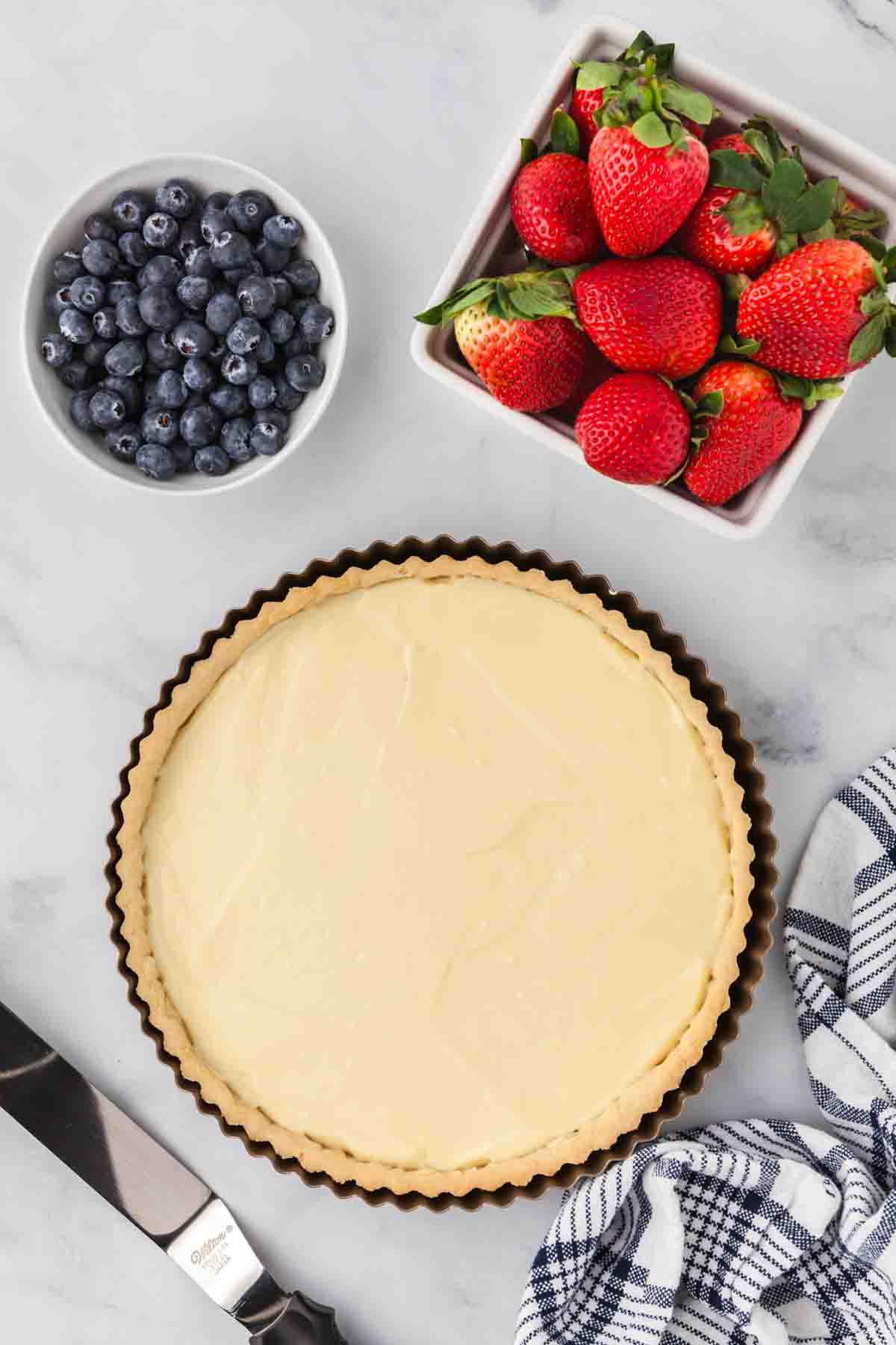 Pastry cream spread into a tart shell.