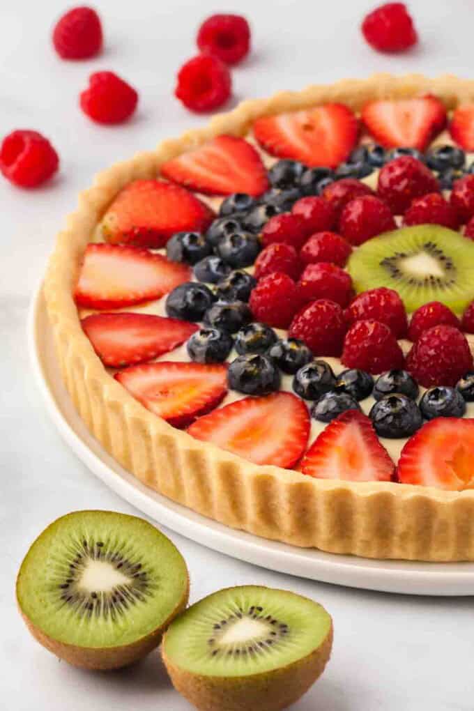 An image of a french fruit tart on a plate.