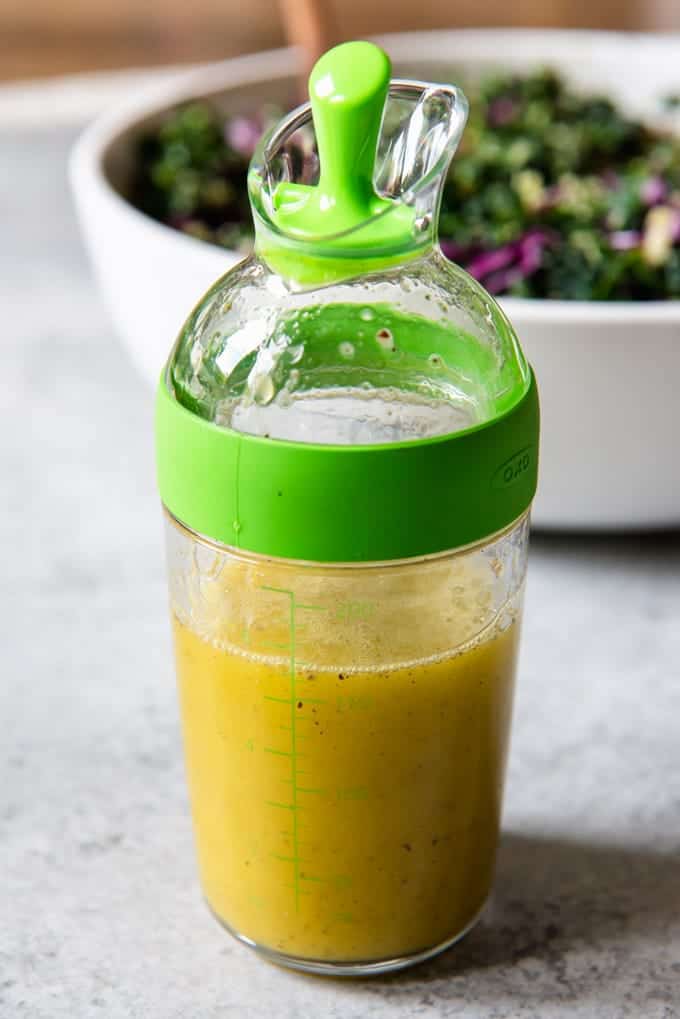 An image of a bottle of lemon vinaigrette for a chopped kale salad.