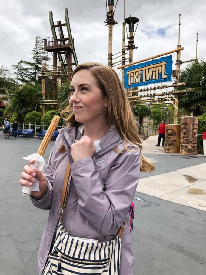 An image of a woman eating a churro at California's Great America amusement park.