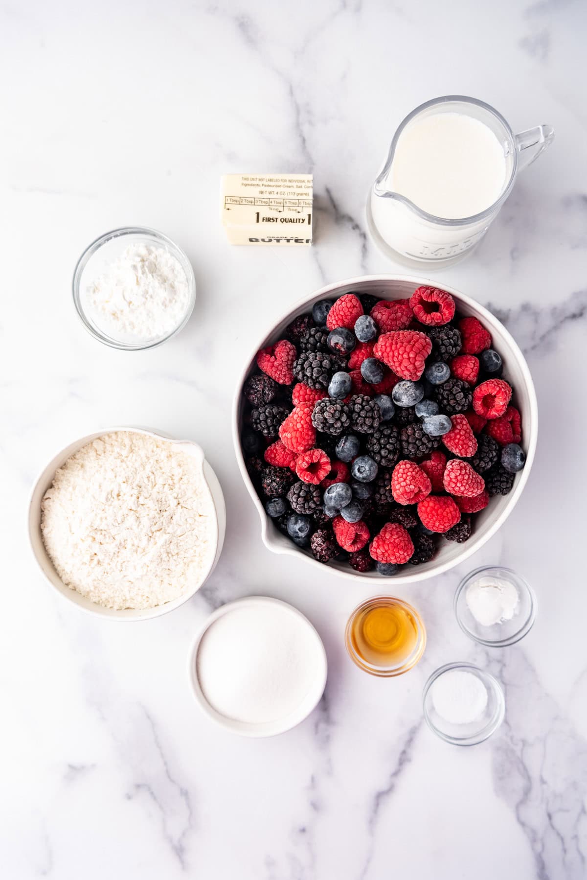 Ingredients for making a mixed berry cobbler.