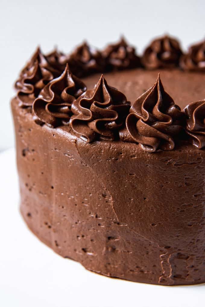 An image of a cake frosted with chocolate frosting.