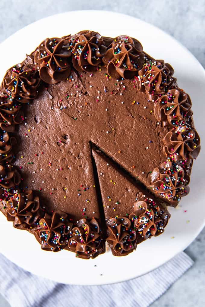 a chocolate frosted cake with a slice cut