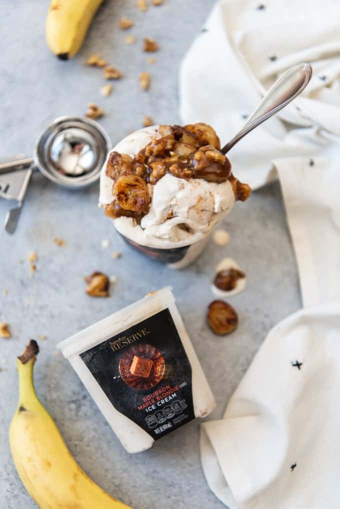 An image of an ice cream sundae made with caramelized bananas, walnuts, and butterscotch sauce over bourbon maple blondie ice cream.