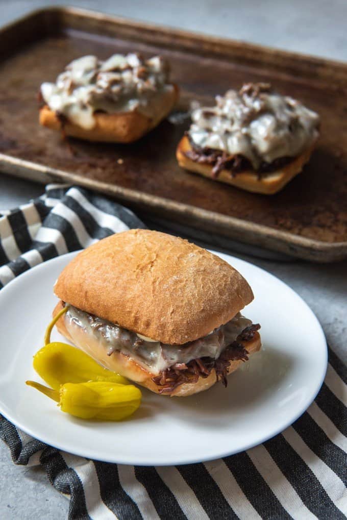 An image of pepperoncini beef sandwiches, also known as Mississippi pot roast sandwiches, made in the slow cooker.