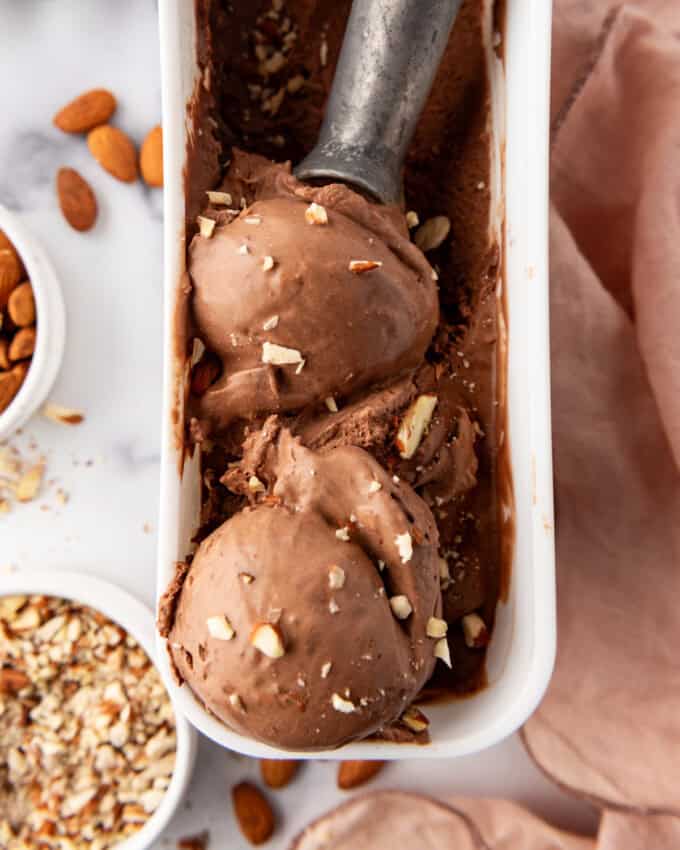 A close up image of scoops of rich burnt almond fudge chocolate ice cream.