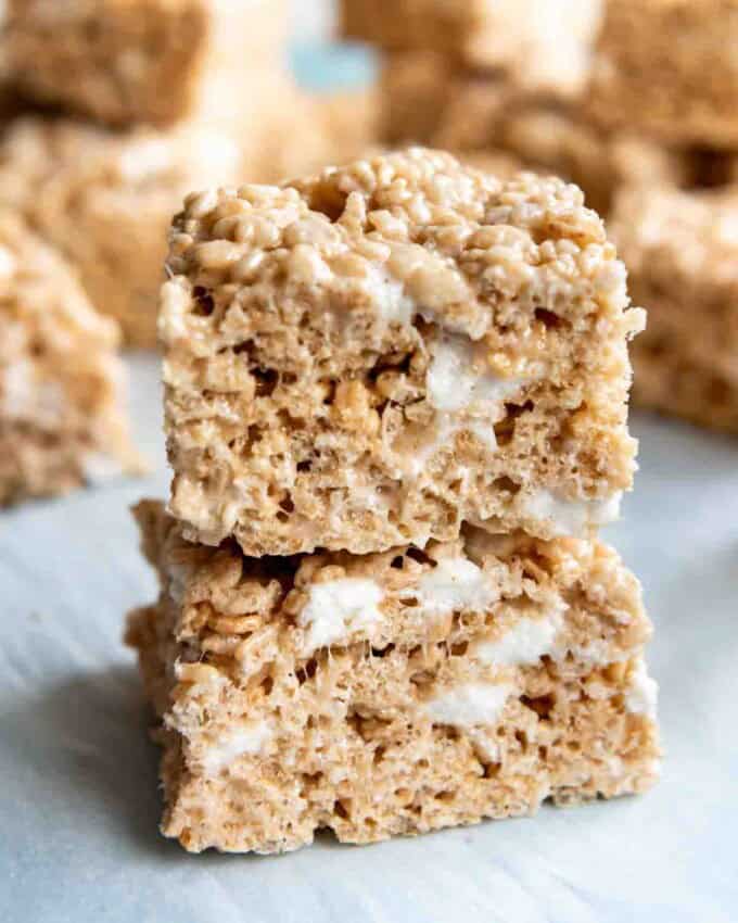 An image of gooey rice krispie treats stacked on top of each other.