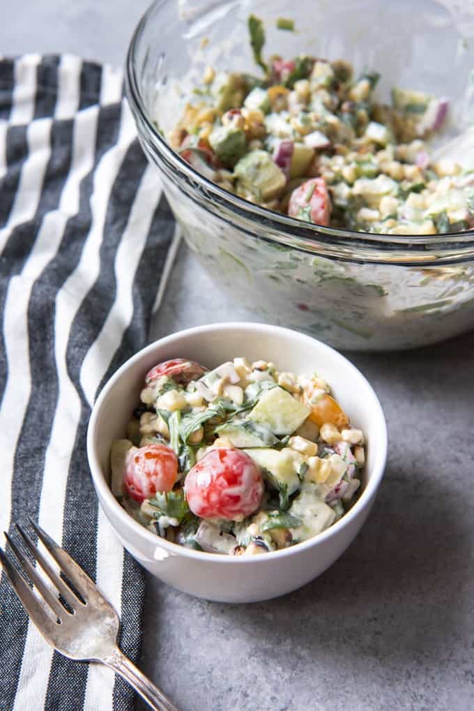 An image of a bowl of grilled corn salad made with a creamy mayo dressing.