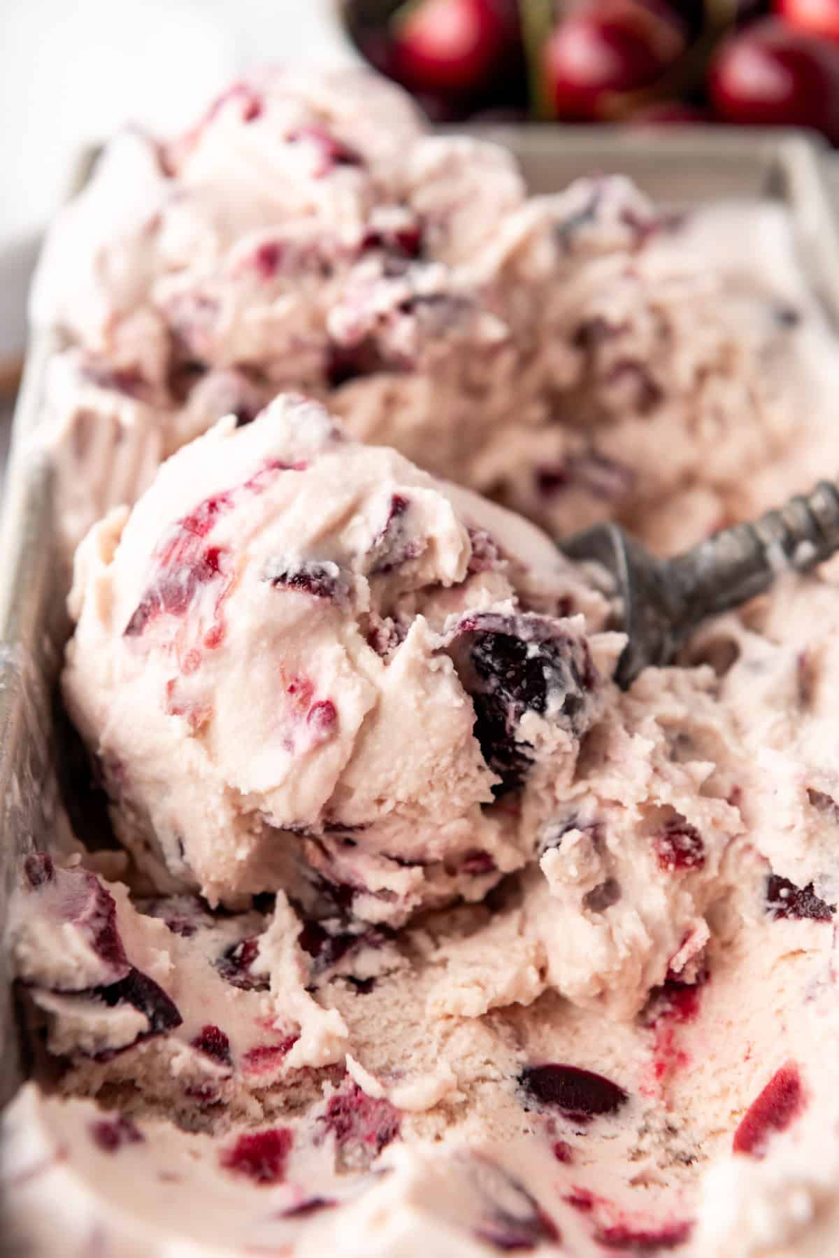 A close image of a scoop of black cherry ice cream.