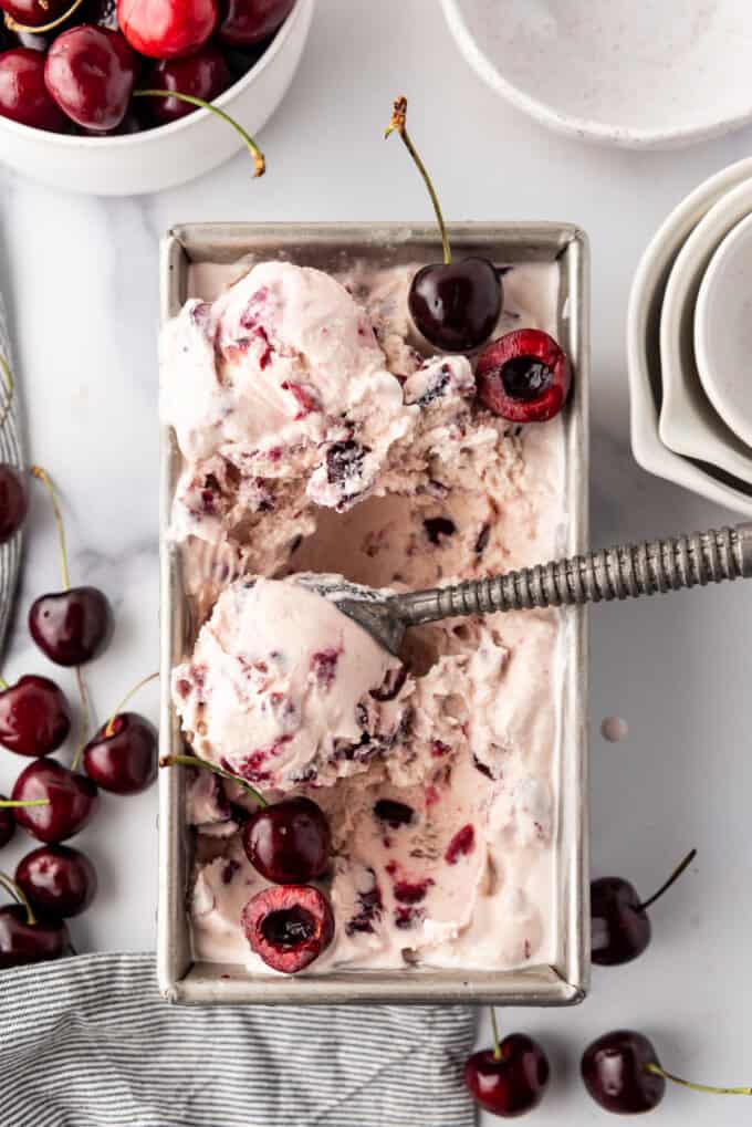 An overhead image of a container of homemade black cherry ice cream.