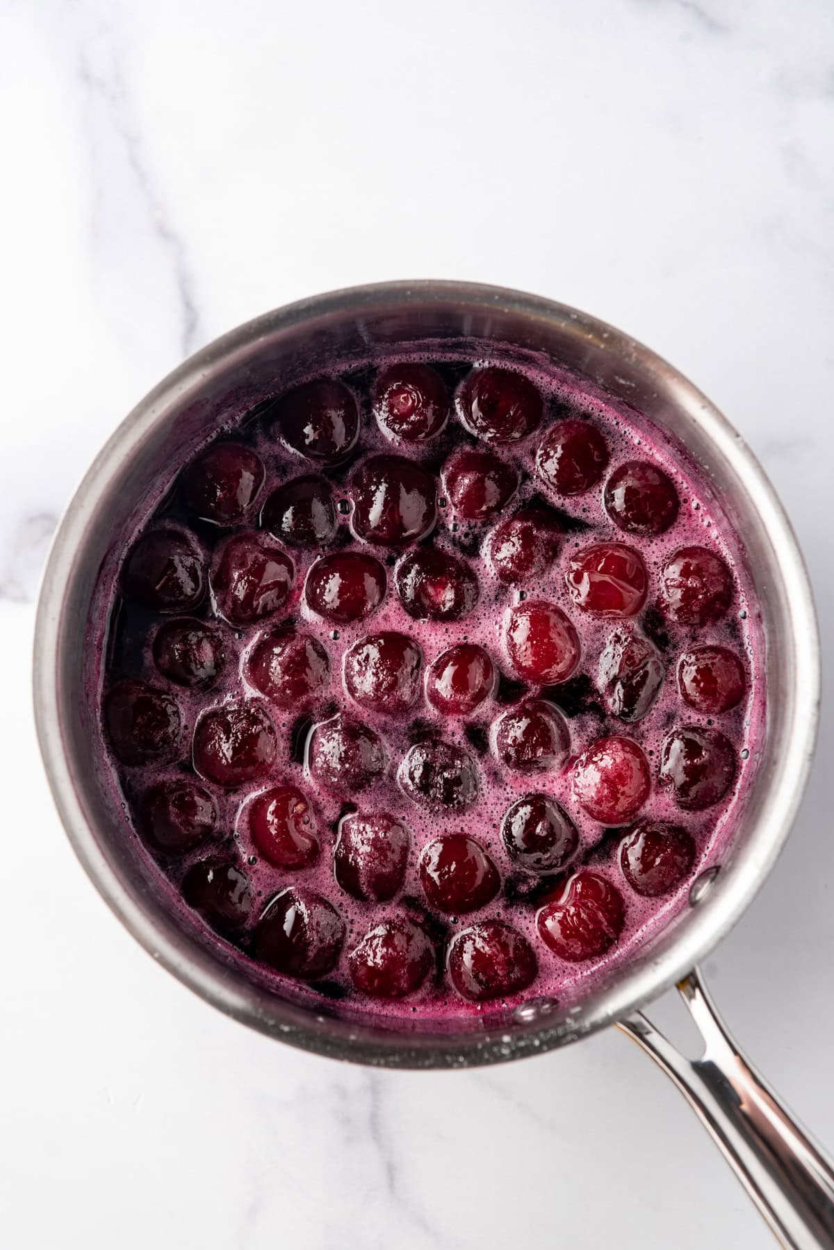 Poached cherries in a saucepan.