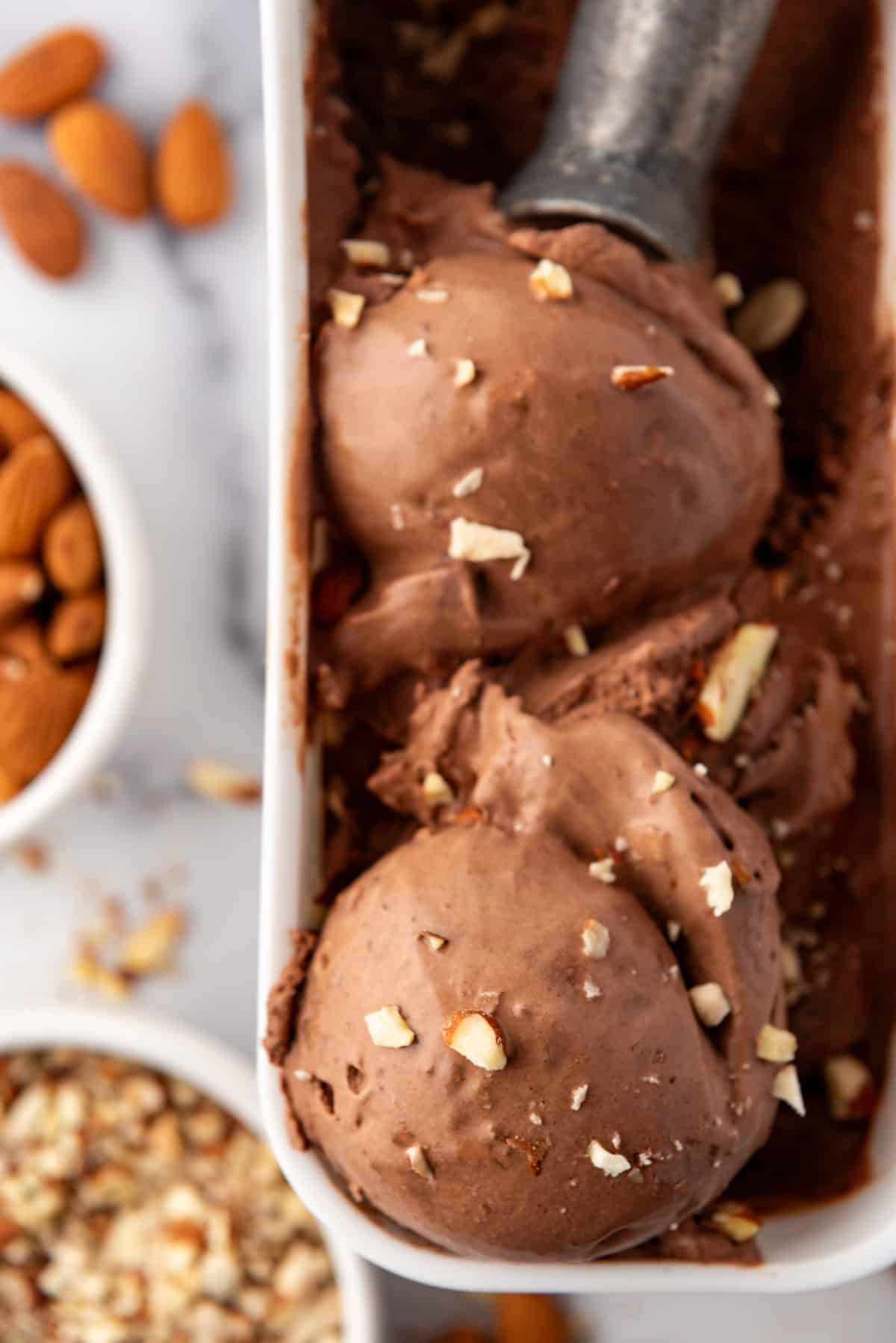 A close up image of scoops of burnt almond fudge ice cream.