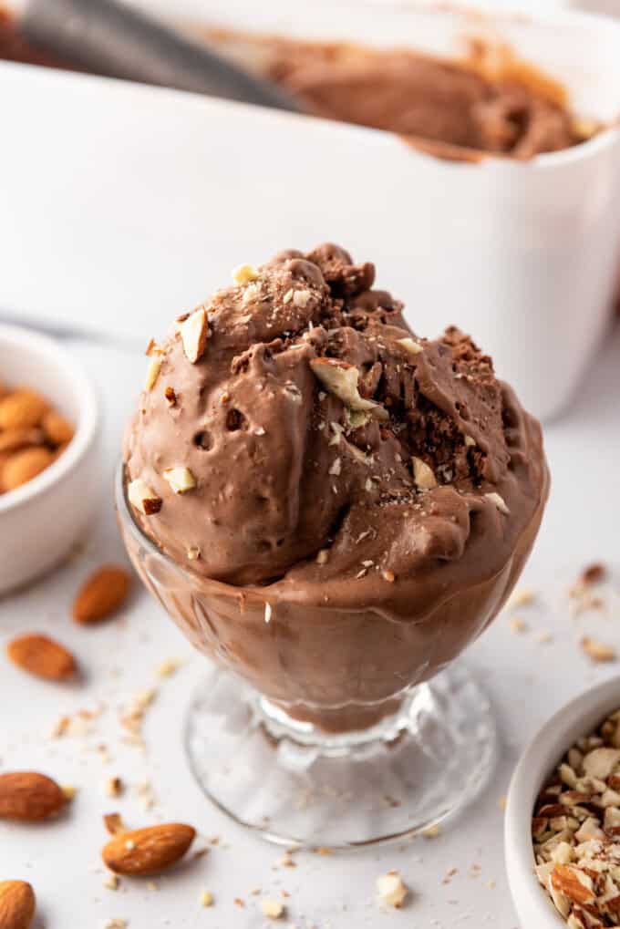 Scoops of burnt almond fudge ice cream in a glass dish.