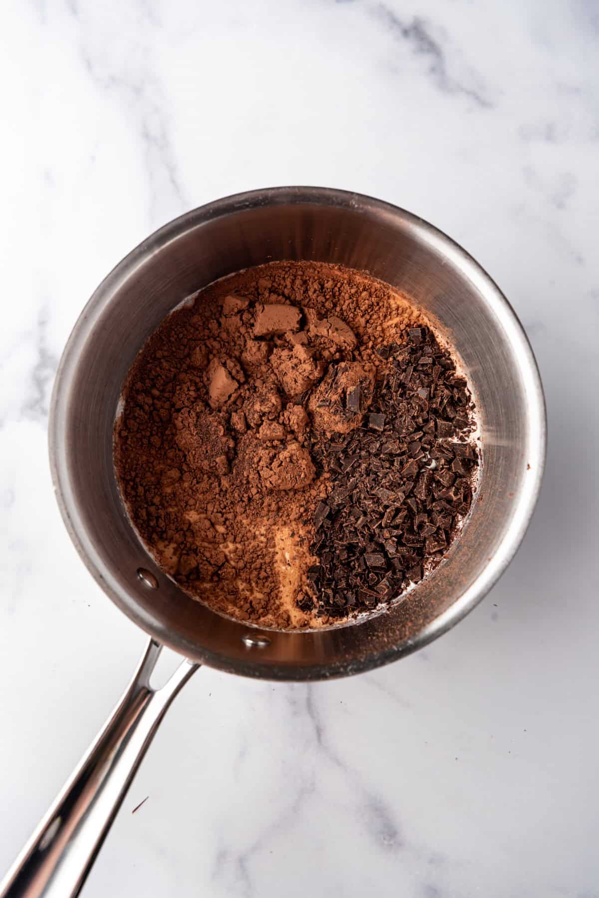 Combining heavy cream, milk, sugar, cocoa powder, and chopped chocolate in a saucepan.