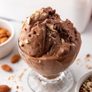 Scoops of burnt almond fudge ice cream in a glass dish.