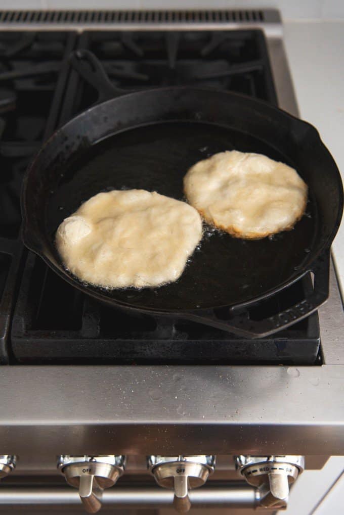 An image of pan fried bread in a skillet full of hot oil for making Navajo tacos.