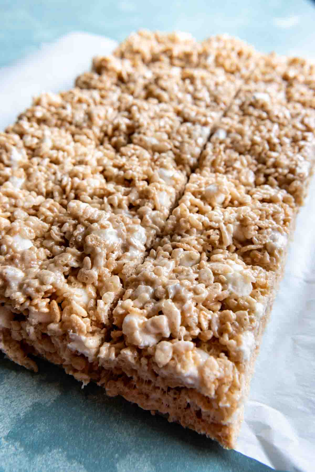 An image of a batch of rice krispy treats cut into squares.