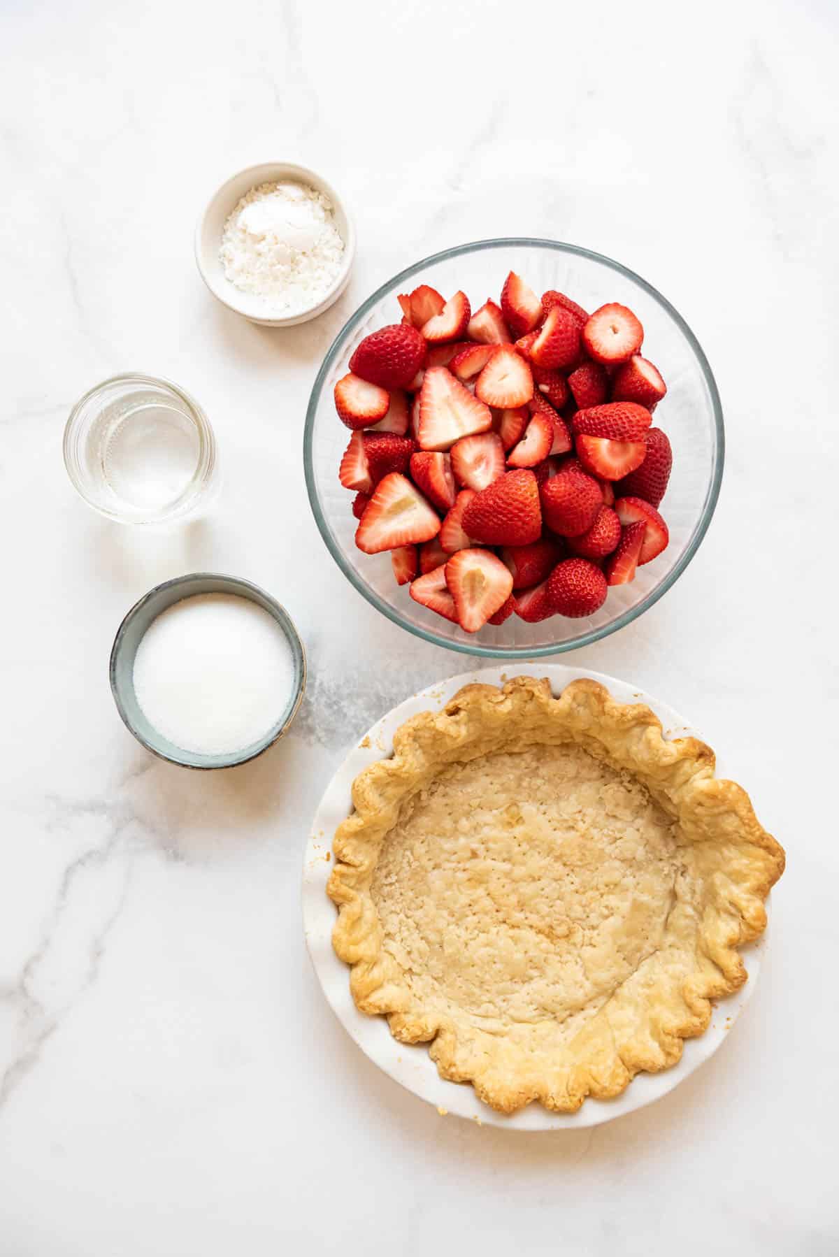 Ingredients for a fresh strawberry pie.