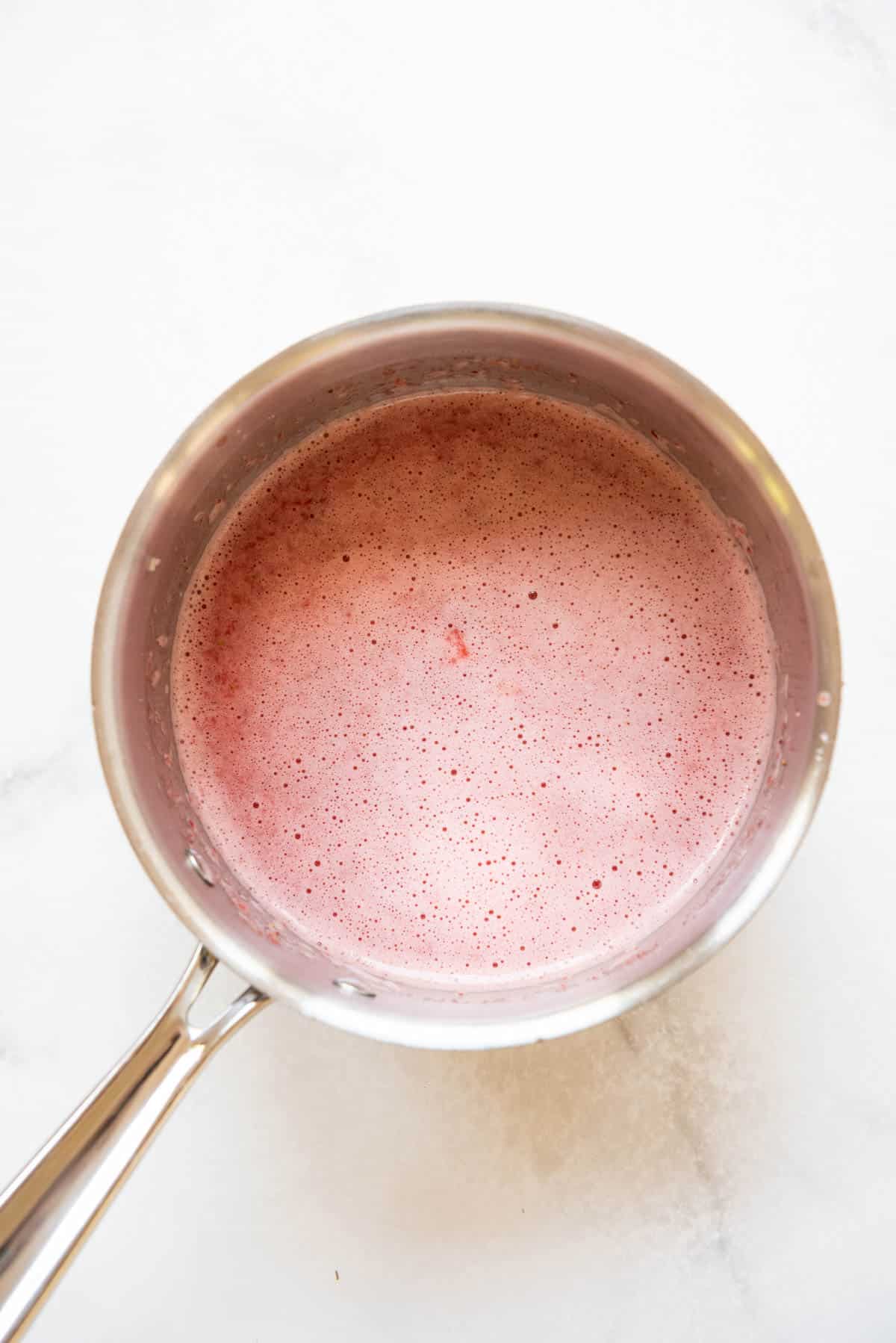 Combining pureed strawberries, sugar, water, and cornstarch in a saucepan.