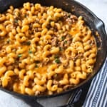 A square image of homemade hamburger helper in a cast iron skillet.