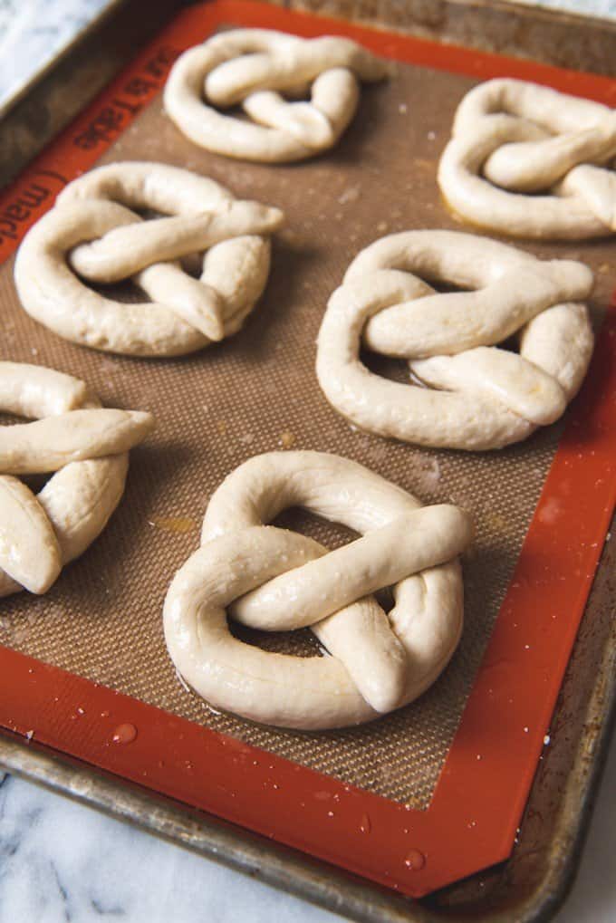 An image of homemade pretzel dough on a baking sheet.