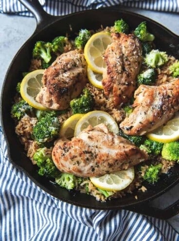 a cast iron skillet with lemon chicken rice inside