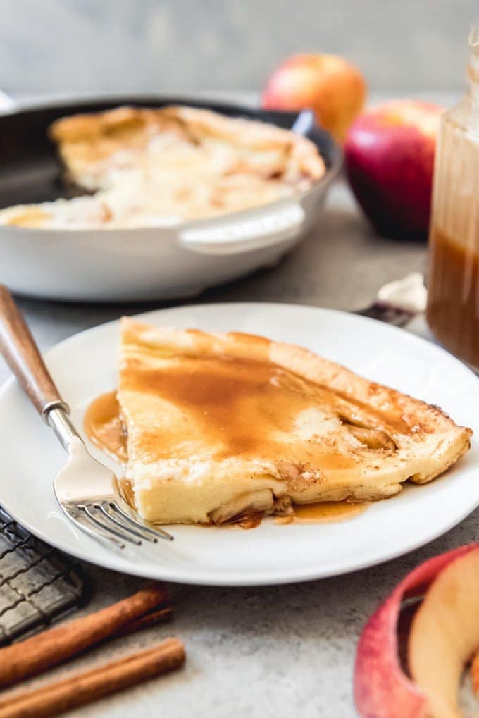 An image of a slice of German apple pancake covered in homemade cider syrup for a delicious Fall breakfast.