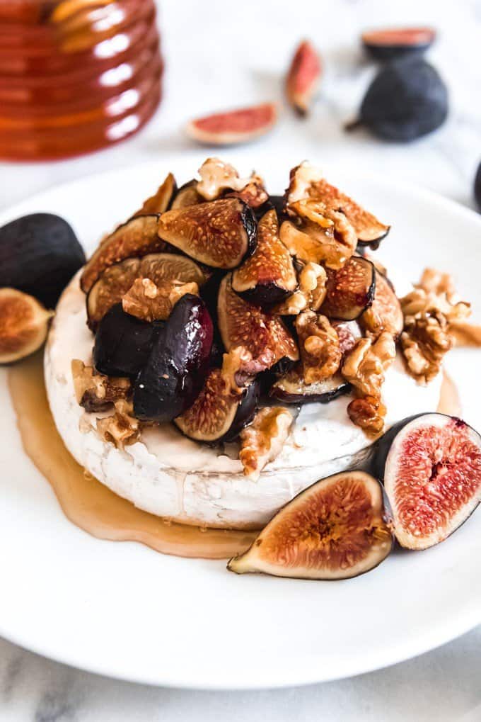 An image of one of the best baked brie recipes with gooey honey, toasty walnuts, and sweet figs.