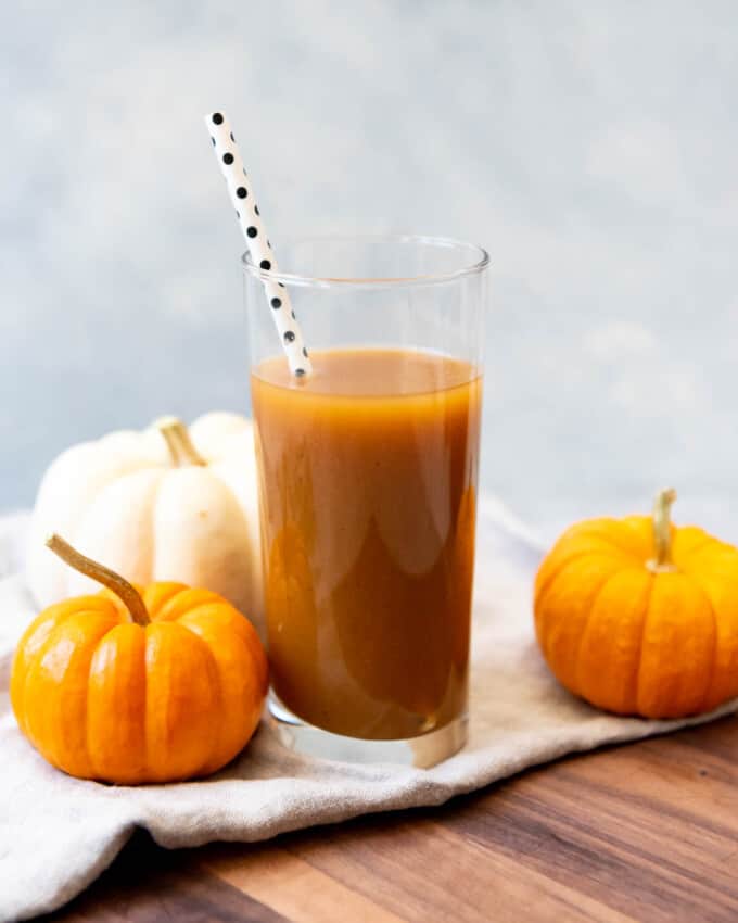 A tall glass of cold pumpkin juice.