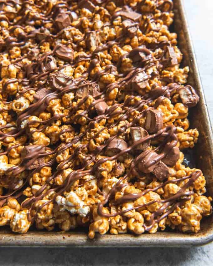 A baking sheet filled with Twix caramel popcorn.